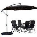 Outdoor 6 Person Rectangular Glass Top Garden Dining Table Chairs With Black Banana Lit Parasol and Base Set